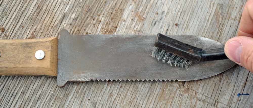 A close up of a saw with a brush on it