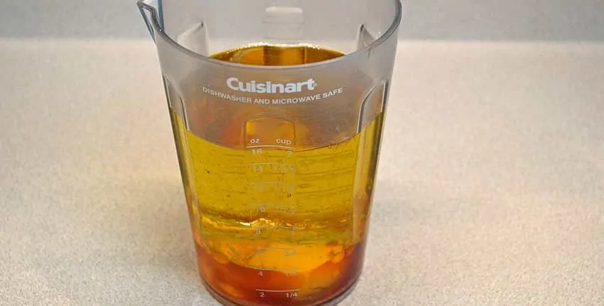 A glass of liquid is sitting on the table.