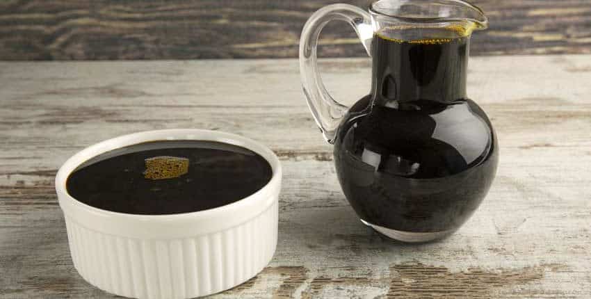 A jar of coffee and a container on the table.