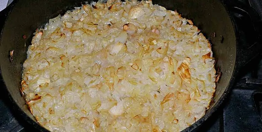 A bowl of rice and meat is ready to be eaten.