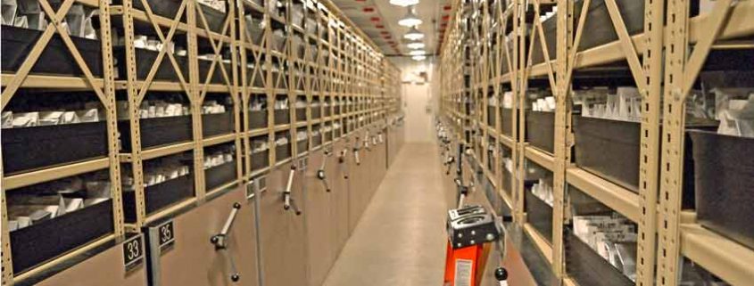 A long hallway with many shelves of books.