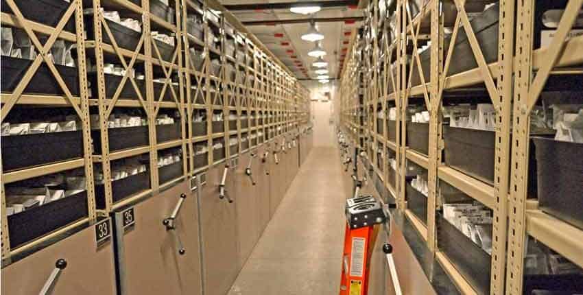 A long hallway with many shelves of books.