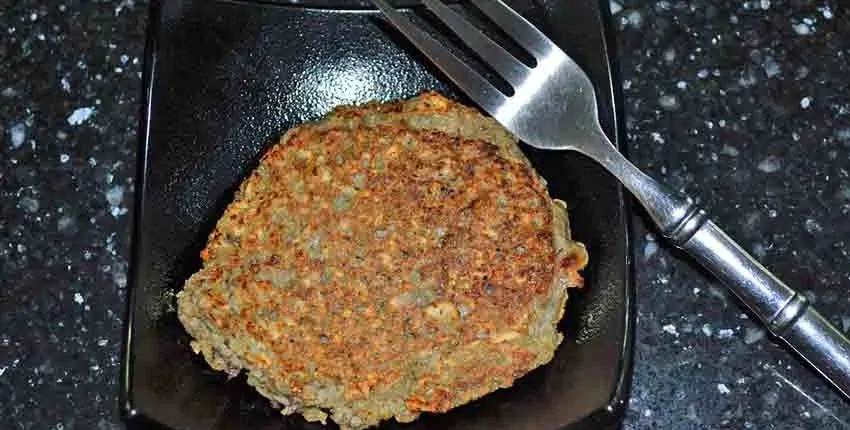 A fork and some food on a plate.