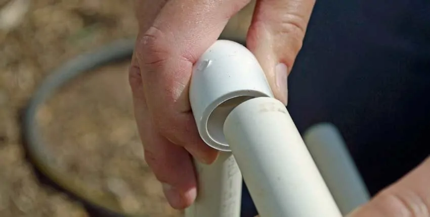 A person holding onto the handle of a pipe.