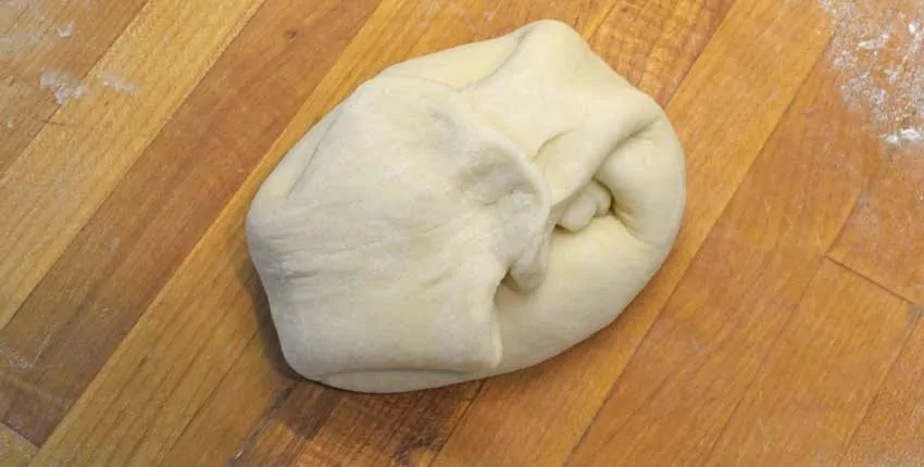 A dough is sitting on the floor and ready to be rolled.