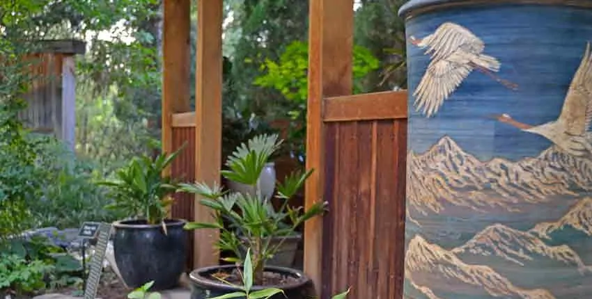 A wooden structure with plants in pots next to it.