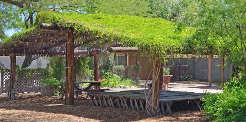 A wooden structure with grass on top of it.