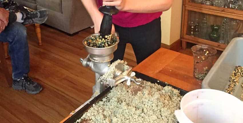 A person using a grinder on some food.