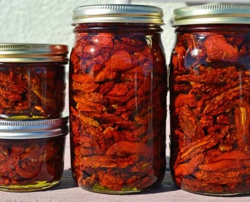 A group of jars filled with food on top of a table.