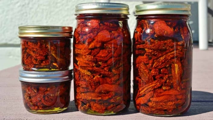 A group of jars filled with food on top of a table.