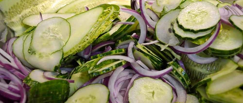 A close up of some cucumbers and onions