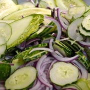 A close up of some cucumbers and onions