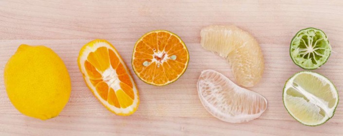 A close up of an orange and some other fruit