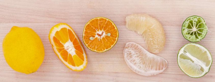 A close up of an orange and some other fruit