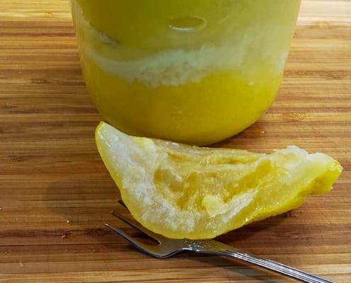 A close up of an orange and a spoon