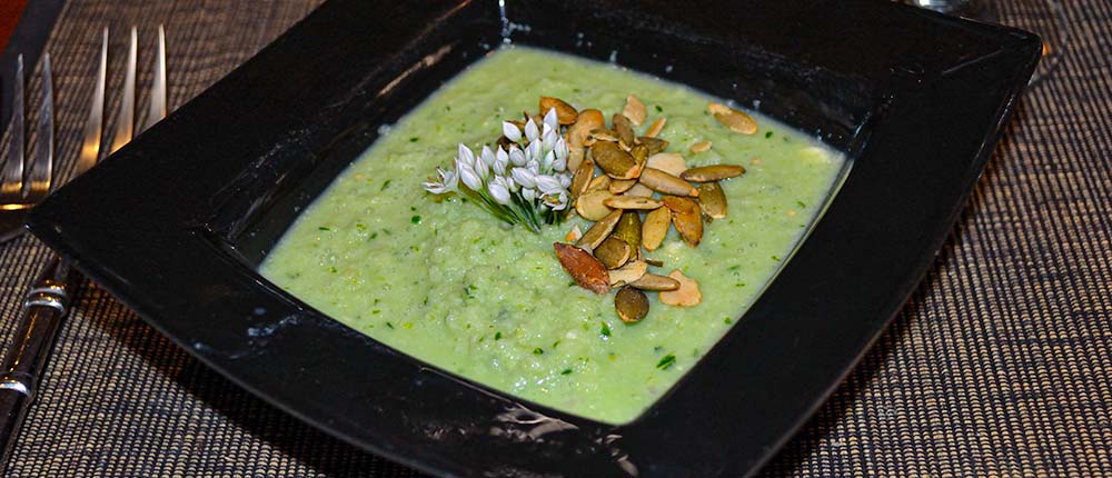 Cucumber gazpacho with chive flowers.