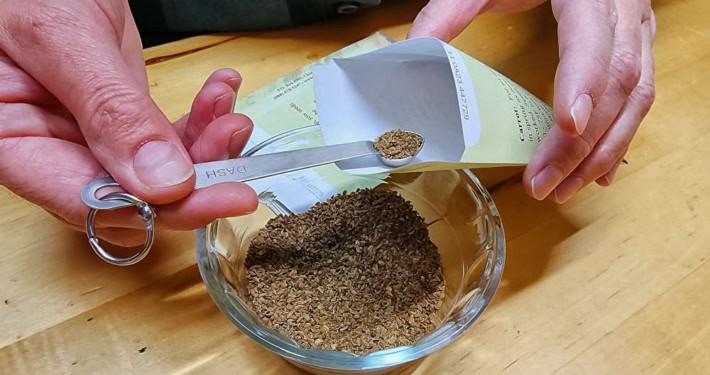 Hand Packing Seeds with Scoop